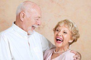 Senior couple in love, smiling because they got same day dentures in time for daughters wedding