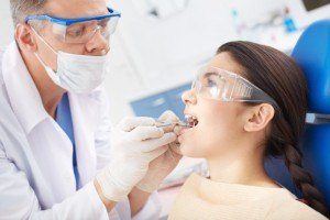 Dentist taking care of little girl oral health.