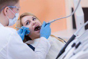 Woman receiving endodontic therapy from dentist.