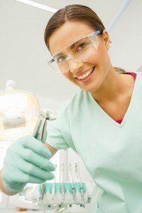 Dentist holding dental forceps and smiling used for extractions