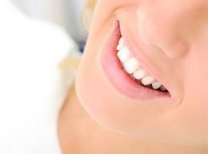 Lady with beautiful, straight and white smile from dental bonding