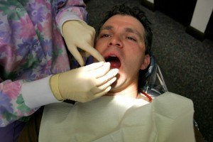Patient being prepped and checked before root canal therapy.
